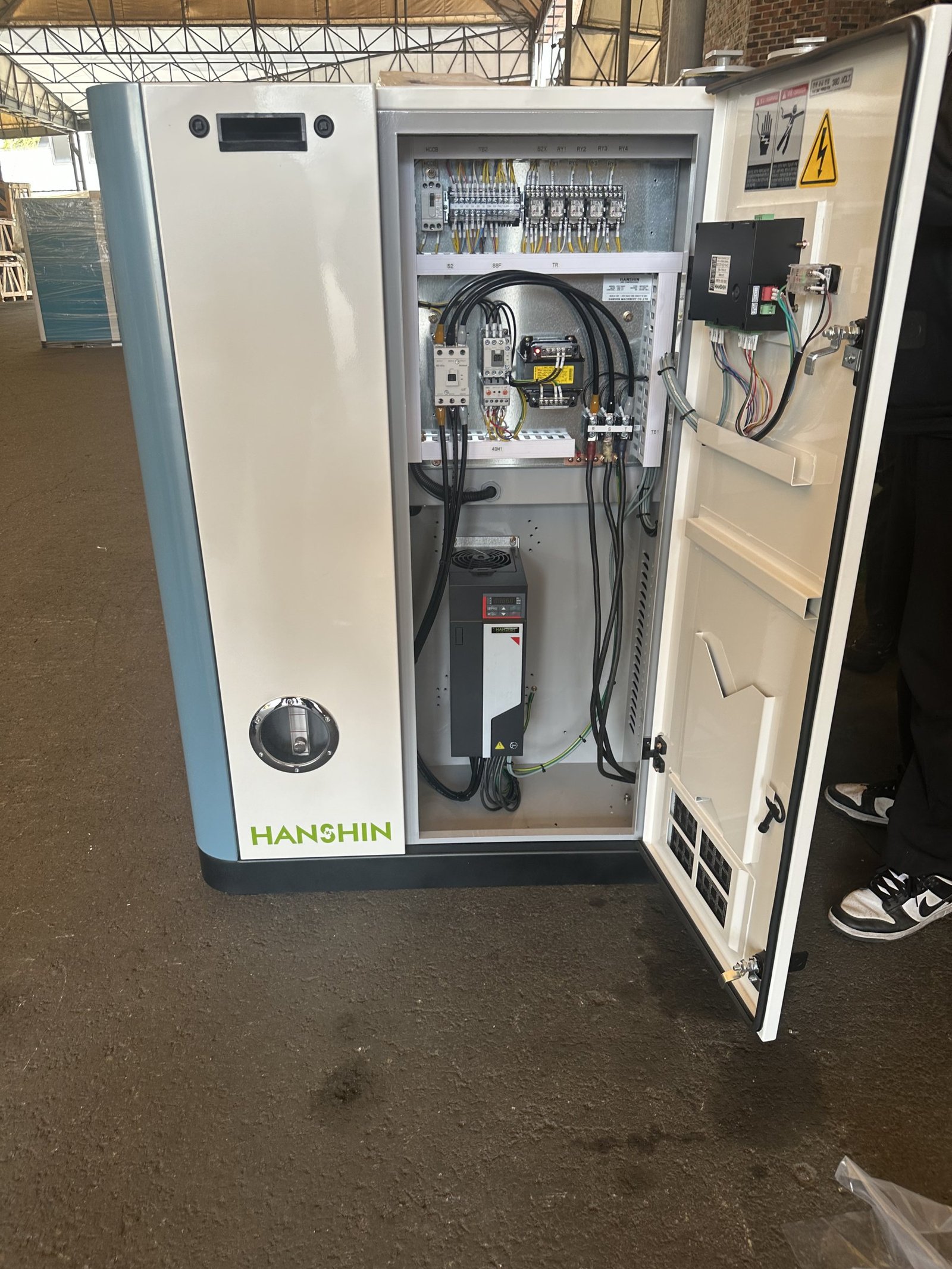 Open compressor control cabinet with an installed variable frequency drive
