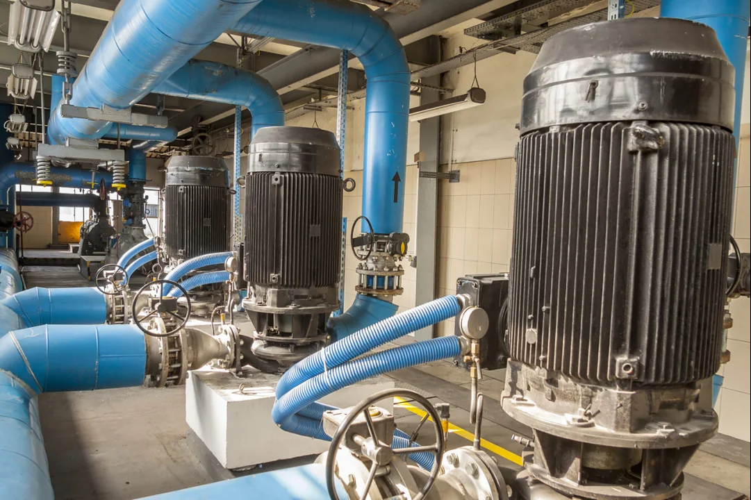Large pump motors connected to blue water pipes
